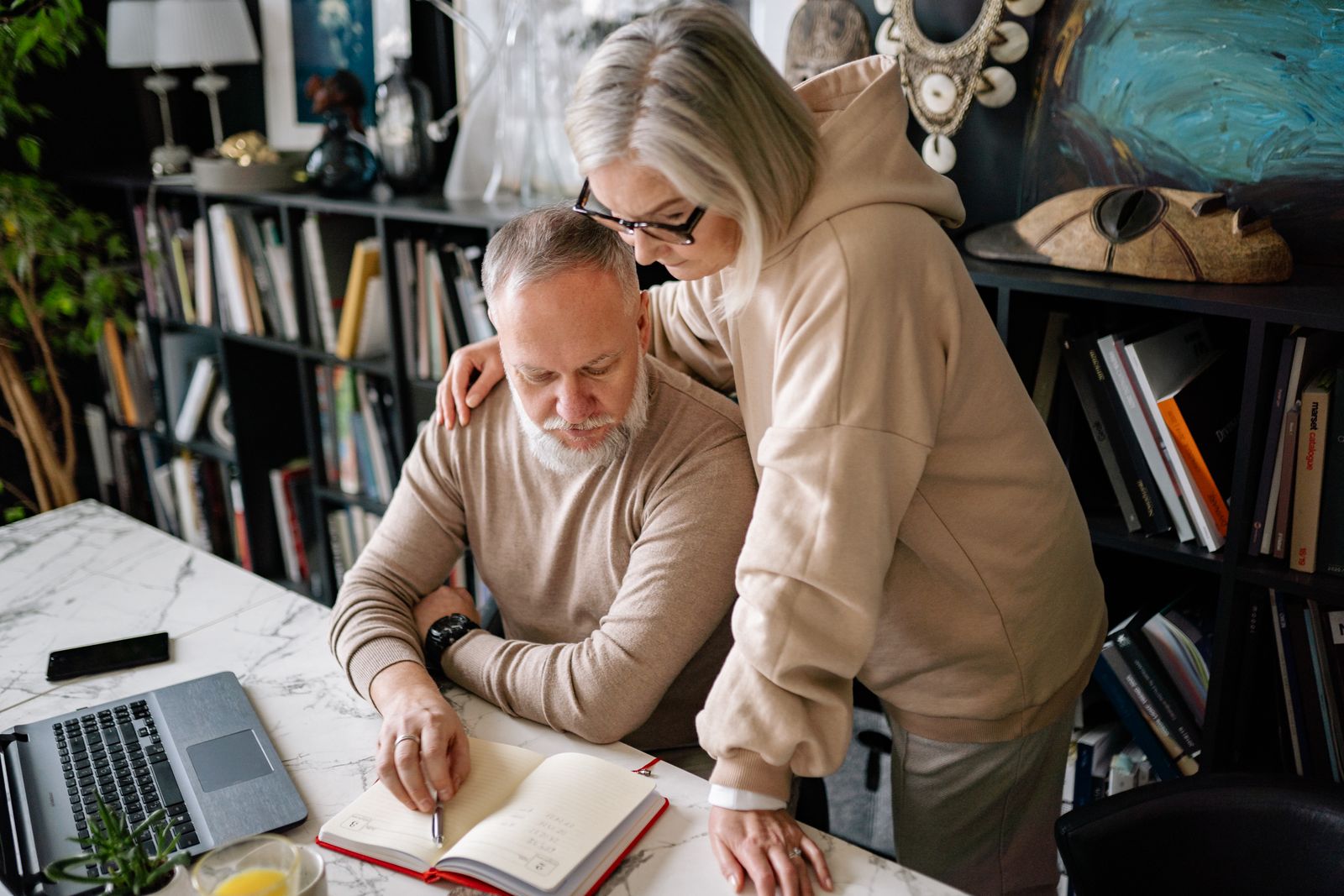 An older couple reviewing notes together at home